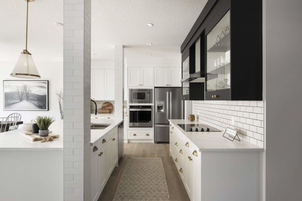 a bright modern kitchen with white kitchen cabinets and a large kitchen island