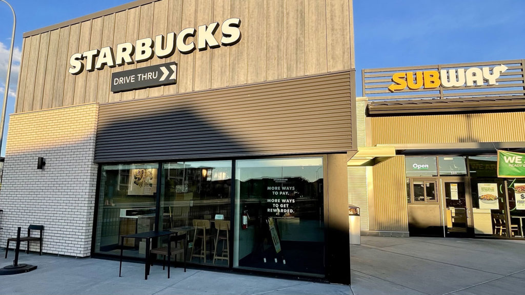 Starbucks store front and Subway at the Township plaza in the community of Legacy in North East Calgary in Alberta in Canada